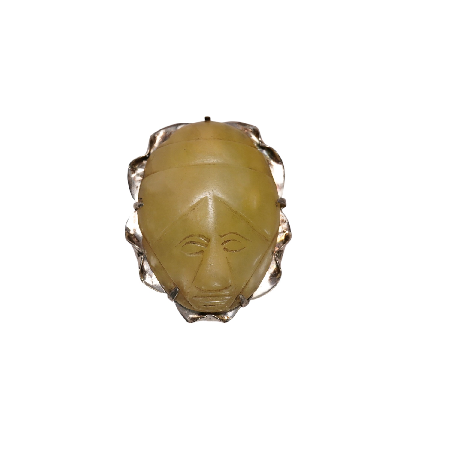 A Mexican silver mounted jadeite brooch, the jadeite face possibly pre-Columbian, 6cm high. Condition - fair, chip to top of brooch